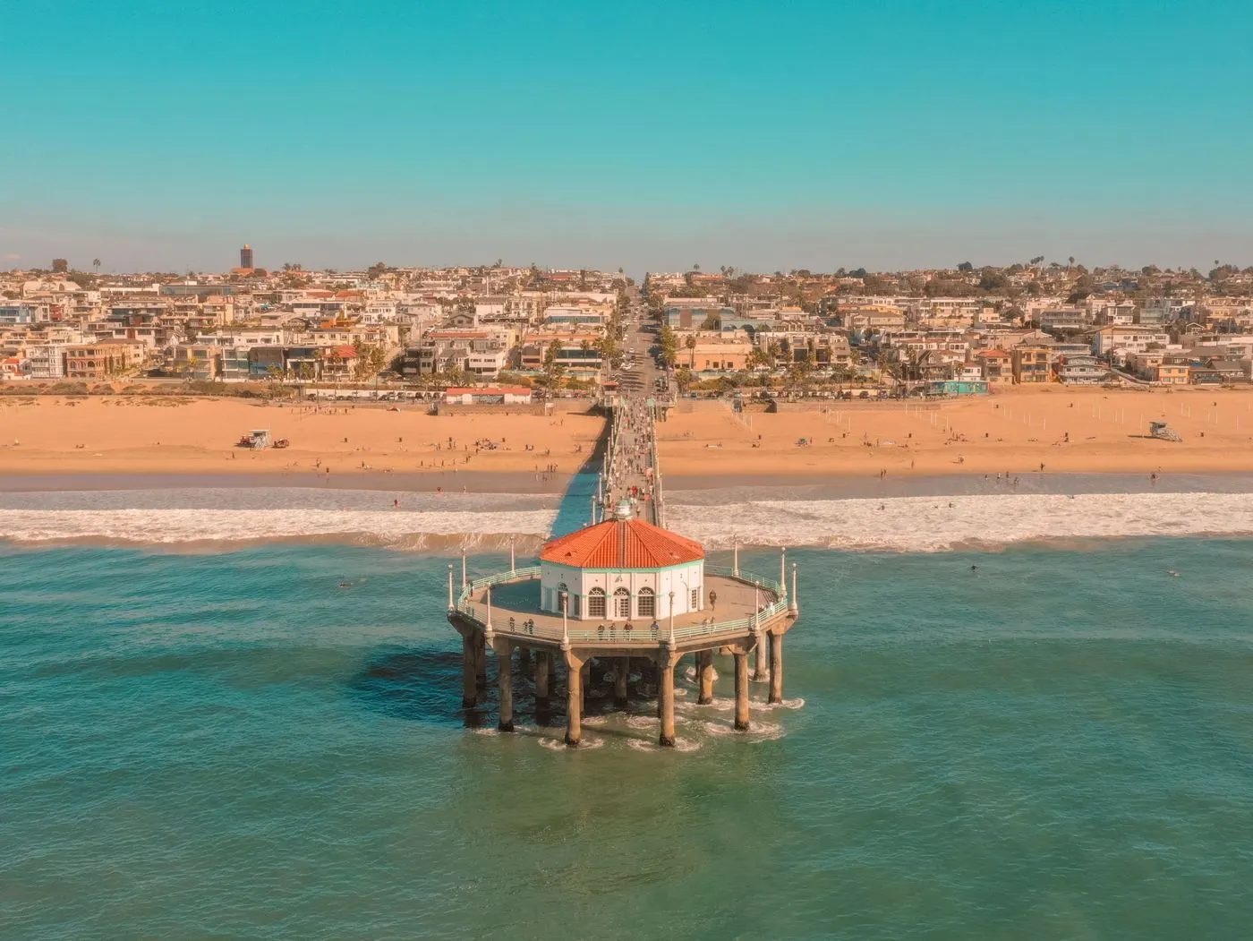 Aerial view of the Manhattan Beach Pier roundhouse over turquoise water