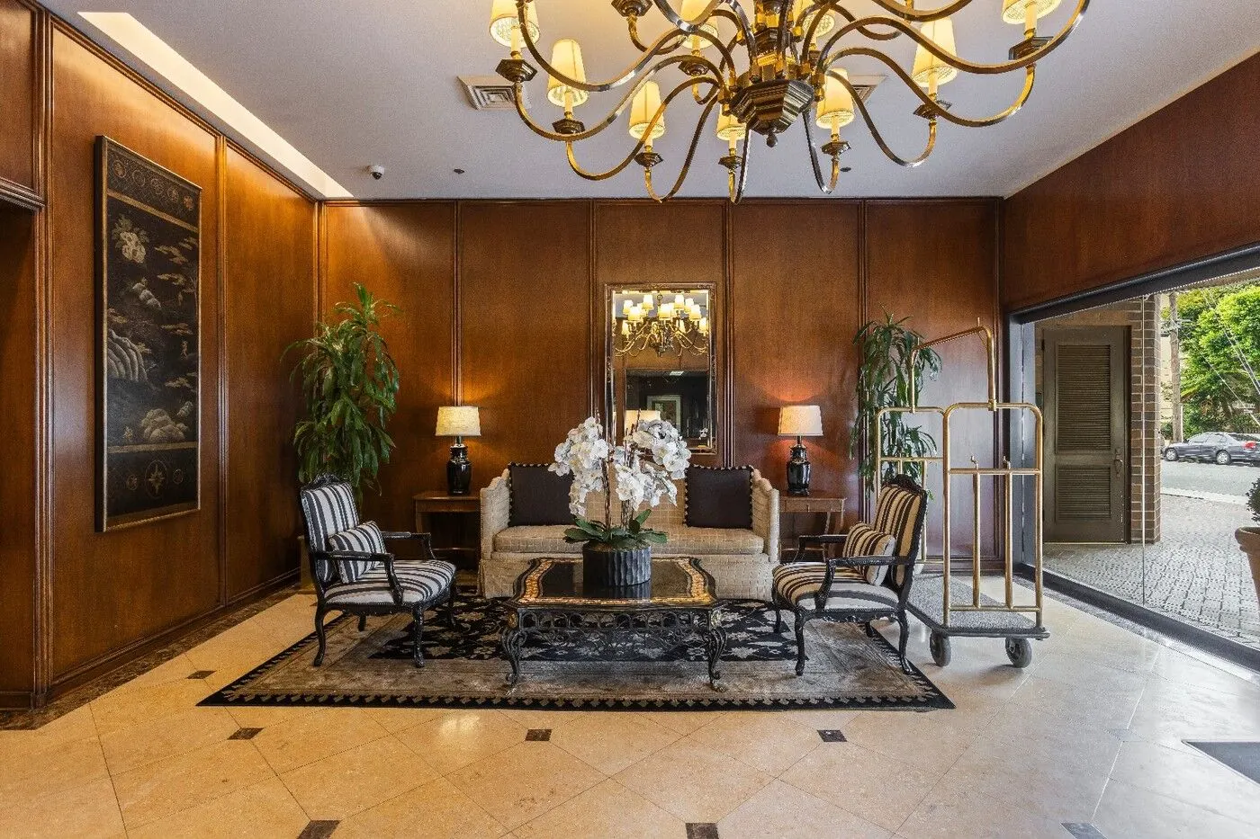 The grand wood paneled lobby with a chandelier at the Wilshire Thayer, 10550 Wilshire Boulevard, Westwood